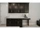 Kitchen features stylish black cabinets with gold hardware and a white subway tile backsplash at 13311 Orca Sound Dr, Riverview, FL 33579