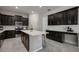 Bright kitchen with a large island, updated appliances, ample counter space, and sleek black cabinets at 13311 Orca Sound Dr, Riverview, FL 33579