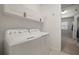 Convenient laundry room with modern washer and dryer, cabinetry, and ample storage at 13311 Orca Sound Dr, Riverview, FL 33579