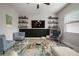Comfortable living room with stylish decor, floating shelves, and comfortable seating at 13311 Orca Sound Dr, Riverview, FL 33579