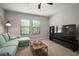 Comfortable living area boasts a large TV, plush sofa, and natural light at 13311 Orca Sound Dr, Riverview, FL 33579