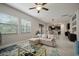 Bright living room with large windows, comfortable seating, and a view into the dining area at 13311 Orca Sound Dr, Riverview, FL 33579
