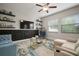 Comfortable living room with stylish decor, floating shelves, and comfortable seating at 13311 Orca Sound Dr, Riverview, FL 33579
