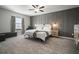Relaxing primary bedroom with paneled wall, soft textures, and comfortable furniture at 13311 Orca Sound Dr, Riverview, FL 33579