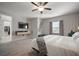 Bright primary bedroom offering a mounted television, comfortable decor, and closet access at 13311 Orca Sound Dr, Riverview, FL 33579