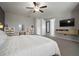 Cozy primary bedroom featuring an accent wall, mounted television, and closet access at 13311 Orca Sound Dr, Riverview, FL 33579