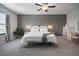 Serene primary bedroom features a decorative accent wall, soft lighting, and cozy decor at 13311 Orca Sound Dr, Riverview, FL 33579