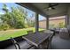 Screened-in patio with ceiling fan and outdoor furniture, overlooking the backyard at 13311 Orca Sound Dr, Riverview, FL 33579
