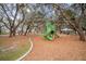 Community playground featuring a slide, climbing structure and shade trees at 13311 Orca Sound Dr, Riverview, FL 33579
