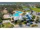 Aerial view showcasing the community pool, clubhouse, tennis courts and manicured grounds at 13311 Orca Sound Dr, Riverview, FL 33579