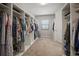 Spacious walk-in closet features built-in shelves and ample storage for clothes and accessories at 13311 Orca Sound Dr, Riverview, FL 33579