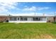 Back of a charming home with a well-maintained lawn at 13612 Veronica Dr, Hudson, FL 34667