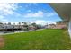 Lush backyard with a view of a canal, dock, and waterfront living at 13612 Veronica Dr, Hudson, FL 34667