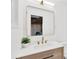 Updated bathroom vanity with modern fixtures, white countertop and decorative mirror at 13612 Veronica Dr, Hudson, FL 34667