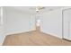 Bright bedroom with wood-look floors, ceiling fan, and closet with sliding doors at 13612 Veronica Dr, Hudson, FL 34667