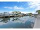 Scenic canal view with docks, boats, and waterfront homes under a blue sky at 13612 Veronica Dr, Hudson, FL 34667