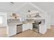 Updated kitchen features stainless steel appliances, open shelving, and stylish backsplash at 13612 Veronica Dr, Hudson, FL 34667