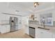 Well-lit kitchen features stainless steel appliances, tile backsplash, and ample cabinet space at 13612 Veronica Dr, Hudson, FL 34667