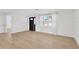 Bright living room featuring neutral flooring, window, and front door at 13612 Veronica Dr, Hudson, FL 34667