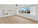 Bright living room with large windows offering scenic canal views and neutral flooring at 13612 Veronica Dr, Hudson, FL 34667