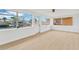 A sun room with large windows overlooking a serene waterfront setting at 13612 Veronica Dr, Hudson, FL 34667