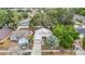 Aerial view of the house and neighborhood with mature trees and a lush canopy at 1432 Windjammer Pl, Valrico, FL 33594