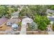 Aerial view of a one-story home, highlighting its metal roof, landscaping, and neighborhood at 1432 Windjammer Pl, Valrico, FL 33594