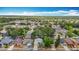 Aerial view of the neighborhood with mature trees and a lake nearby, featuring a well-kept one-story home at 1432 Windjammer Pl, Valrico, FL 33594