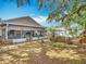 Spacious backyard featuring a screened-in patio and a swing, surrounded by lush landscaping at 1432 Windjammer Pl, Valrico, FL 33594