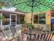 Inviting backyard featuring a patio table and seating, patio, green umbrella, and lush landscaping at 1432 Windjammer Pl, Valrico, FL 33594