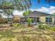 Backyard features a screened-in patio, paver patio with dining set, and lush landscaping at 1432 Windjammer Pl, Valrico, FL 33594