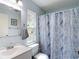 Bathroom featuring a mirror, towel rack, sink, toilet and marble shower curtain at 1432 Windjammer Pl, Valrico, FL 33594