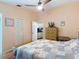 Comfortable bedroom featuring a ceiling fan and beautiful wood furnishings and flooring at 1432 Windjammer Pl, Valrico, FL 33594