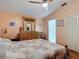 Comfortable bedroom featuring a ceiling fan and beautiful wood furnishings and flooring at 1432 Windjammer Pl, Valrico, FL 33594