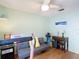 Bedroom featuring a ceiling fan, desk, and a gray futon with wooden floors at 1432 Windjammer Pl, Valrico, FL 33594