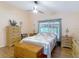 Comfortable bedroom featuring a ceiling fan and beautiful wood furnishings and flooring at 1432 Windjammer Pl, Valrico, FL 33594