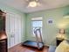 Bedroom featuring a ceiling fan, closet, and a treadmill with wooden floors at 1432 Windjammer Pl, Valrico, FL 33594