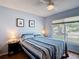 Cozy bedroom with natural light, ceiling fan, and wood-look flooring at 1432 Windjammer Pl, Valrico, FL 33594