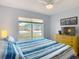 Bedroom with a large window, a yellow dresser, and a ceiling fan at 1432 Windjammer Pl, Valrico, FL 33594