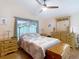 Comfortable bedroom featuring a ceiling fan and beautiful wood furnishings and flooring at 1432 Windjammer Pl, Valrico, FL 33594