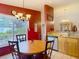 Cozy dining space near the kitchen, featuring a window with backyard views and elegant lighting at 1432 Windjammer Pl, Valrico, FL 33594