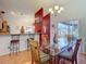 Bright dining room with glass table, modern lighting, and sliding glass doors to a screened patio at 1432 Windjammer Pl, Valrico, FL 33594