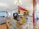 Open-concept dining room with a glass table, open to the living room and kitchen bar area at 1432 Windjammer Pl, Valrico, FL 33594