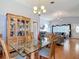 Comfortable dining room with glass table set, hutch, and access to the living room at 1432 Windjammer Pl, Valrico, FL 33594