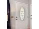 Interior view of front door with decorative glass, hardware, and adjacent closet at 1432 Windjammer Pl, Valrico, FL 33594