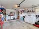 A functional garage with a washer, dryer, shelving, and space for storage and activities at 1432 Windjammer Pl, Valrico, FL 33594