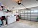 Spacious garage featuring a washer, dryer, shelving, and a garage door with plenty of natural light at 1432 Windjammer Pl, Valrico, FL 33594