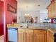 Open kitchen with granite countertops, stainless steel dishwasher, and views of the dining and living areas at 1432 Windjammer Pl, Valrico, FL 33594