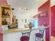 Kitchen bar area with granite countertops and seating open to a cozy dining space at 1432 Windjammer Pl, Valrico, FL 33594