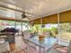 Enclosed lanai with outdoor seating, ceiling fan, and views of the landscaped yard at 1432 Windjammer Pl, Valrico, FL 33594
